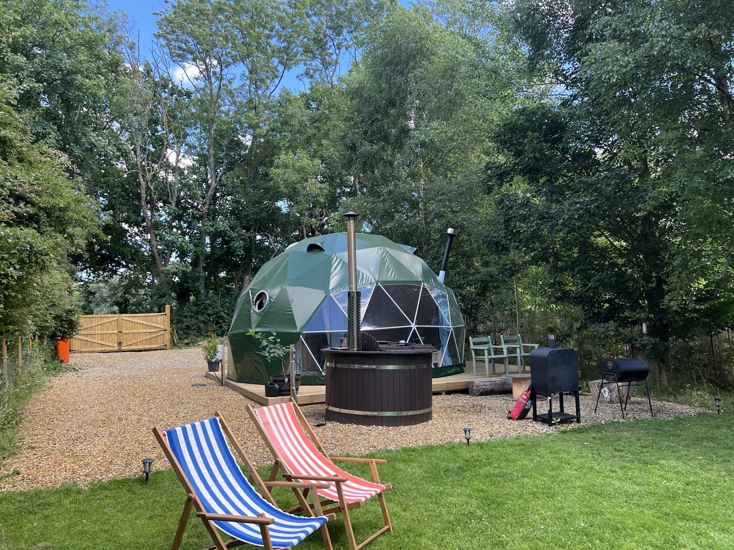 Handmade timber king-size bed and dining space inside Cherry Tree Dome